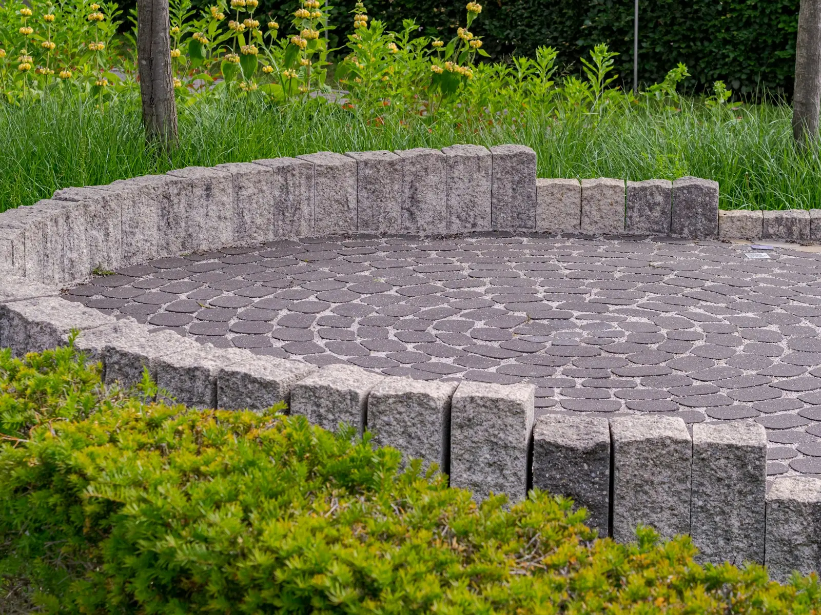 Circular hardscape feature with stone and plantings